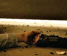a person laying on the ground with their hand reaching out