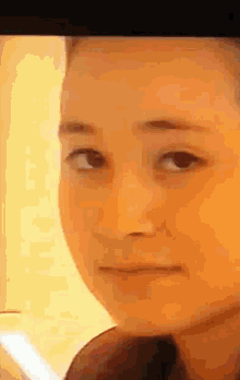 a close up of a young girl 's face with a serious look on her face