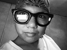a black and white photo of a person wearing glasses
