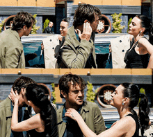 a man and a woman are standing next to each other and the woman is touching the man 's face