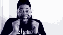 a black and white photo of a man wearing a t-shirt that says `` let 's go '' .