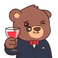 a teddy bear in a suit and bow tie is holding a glass of red wine