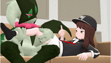 a girl is laying on a couch next to a monster with a hat that has the letter a on it