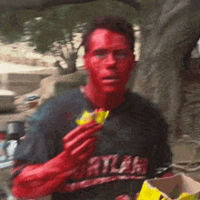 a man with red paint on his face wearing a shirt that says portland