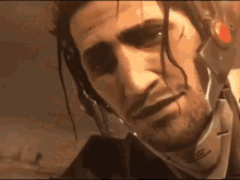 a man with a beard and a helmet on his head .