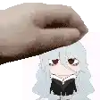 a hand is holding a cartoon girl 's head while she is reading a book .