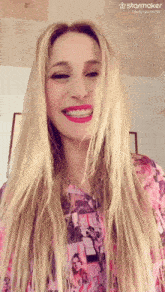 a woman wearing a pink shirt with a starmaker logo on the bottom