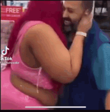 a man and a woman are hugging each other in a store .