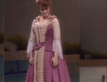a woman in a purple dress with white sleeves and a flower in her hair