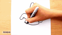 a person drawing with a sharpie marker on a piece of paper