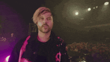a blurry picture of a man 's face with a purple background