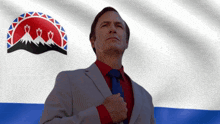 a man in a suit and tie with a flag in the background