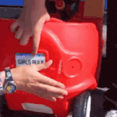 a red toy car has a tag that says girls rule on it
