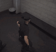 a police officer is kneeling down in front of a brick wall