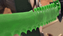 a close up of a green object that looks like a dragon 's teeth