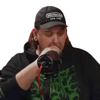 a man wearing a nintendo new york hat holds his hand to his mouth