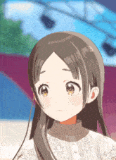 a close up of a girl 's face with long brown hair