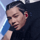 a close up of a person 's face with a braided hair style