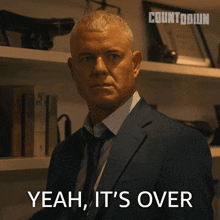 a man in a suit and tie is saying " yeah it 's over "