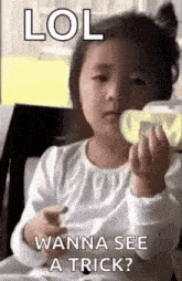 a little girl is sitting at a table holding a bottle of milk and a piece of cheese .