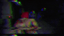 a shirtless man wearing a red headband and sunglasses is standing in a dark room with blue lights behind him .