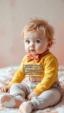 a baby is wearing a yellow shirt and a bow tie