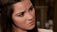 a close up of a woman making a face