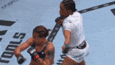 two women are fighting in a ufc fight