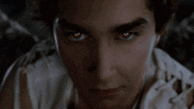 a close up of a man 's face with his eyes glowing