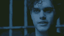 a close up of a man 's face in the dark with his eyes closed .