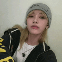 a woman wearing a beanie and a black jacket