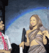 a woman in a purple dress is talking to a man