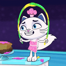 a cartoon cat is jumping a hula hoop in front of a cake on a table