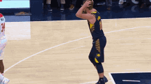 a basketball player wearing a number 1 jersey stands on the court