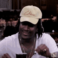 a man wearing a white hat that says culture