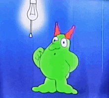a green cartoon character with red horns and a light bulb hanging from the ceiling