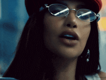 a close up of a woman wearing glasses and earrings