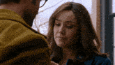 a man and a woman are looking at each other with their eyes closed