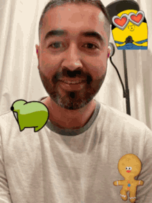 a man with a beard is wearing a shirt with a gingerbread man on it