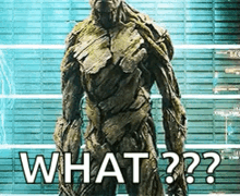a statue of groot from guardians of the galaxy is standing in front of a wall with the words what ?