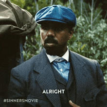 a man wearing a suit and hat says alright