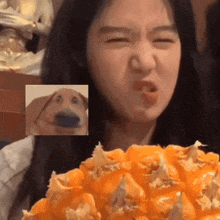 a girl is eating a pineapple with a picture of a dog behind her .