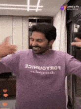 a man is wearing a purple shirt that says ' ioiuoyяo9 ' on it