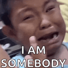 a child is crying with the words " i am somebody " below him
