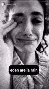 a black and white photo of a woman crying with the words eden arella rain below her