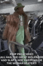 a man in a fur coat and hat is walking on a treadmill .