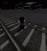 a person is walking down train tracks with a car in the background
