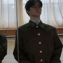 a man in a military uniform is standing in front of a mirror