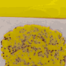 a person is holding a wooden cutting board with a thick brown liquid on it