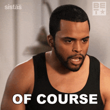 a man wearing a black tank top with the words of course written on it